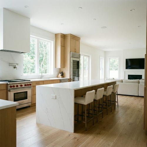 Bright open-plan kitchen with quartz island and white oak floors in a new Lakewood luxury home