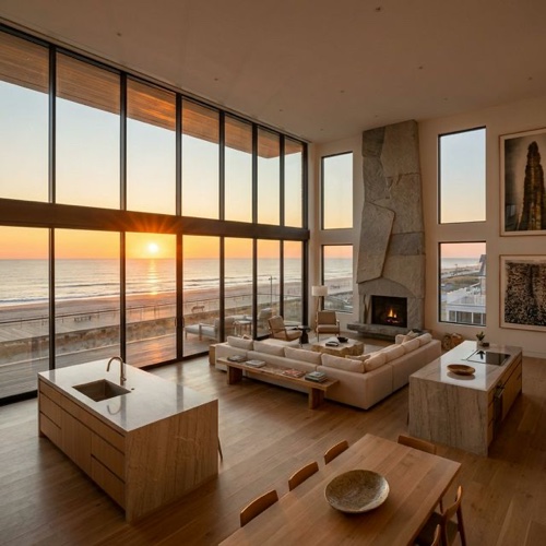 Modern open-plan condo interior with floor-to-ceiling windows and Atlantic Ocean sunset views